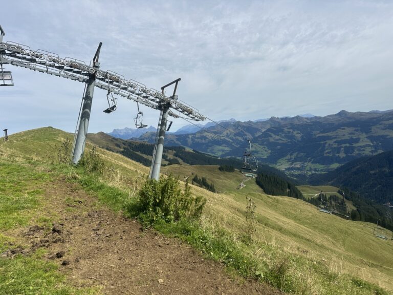 Chairlift on an alpine ridge with revegetated slopes