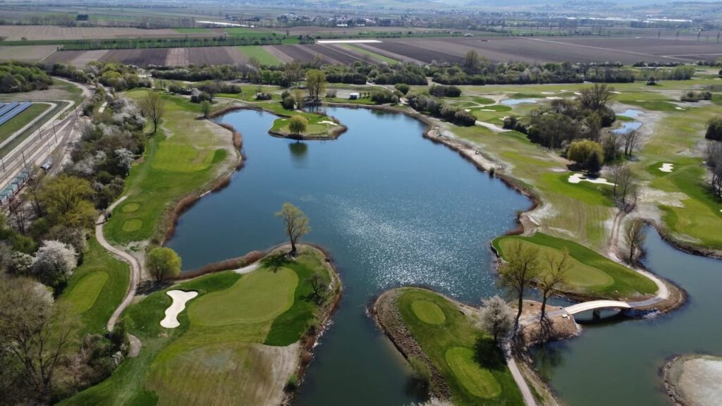 Aerial view of a golf course with lakes, greens and bunkers