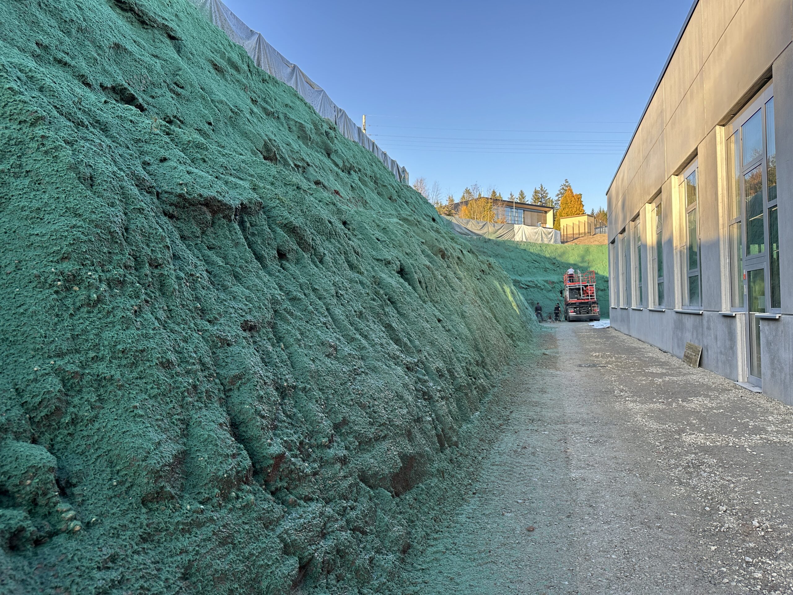 Hydraulically applied erosion control matting on a graded slope