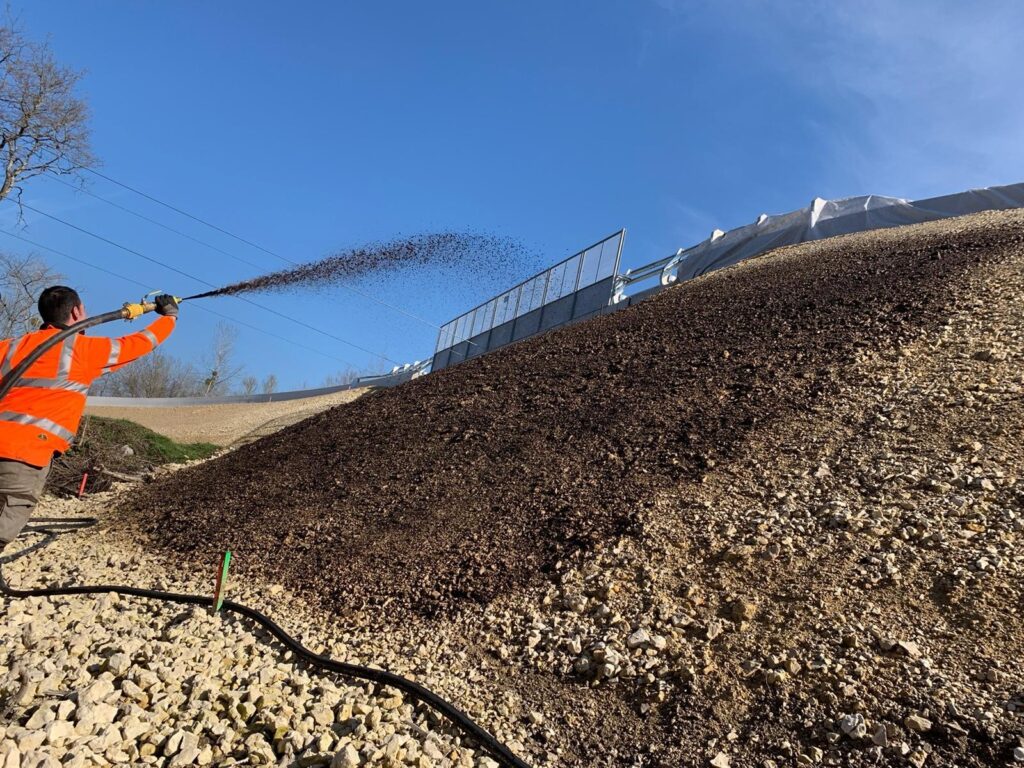 Hydraulically applied topsoil being placed on a prepared surface