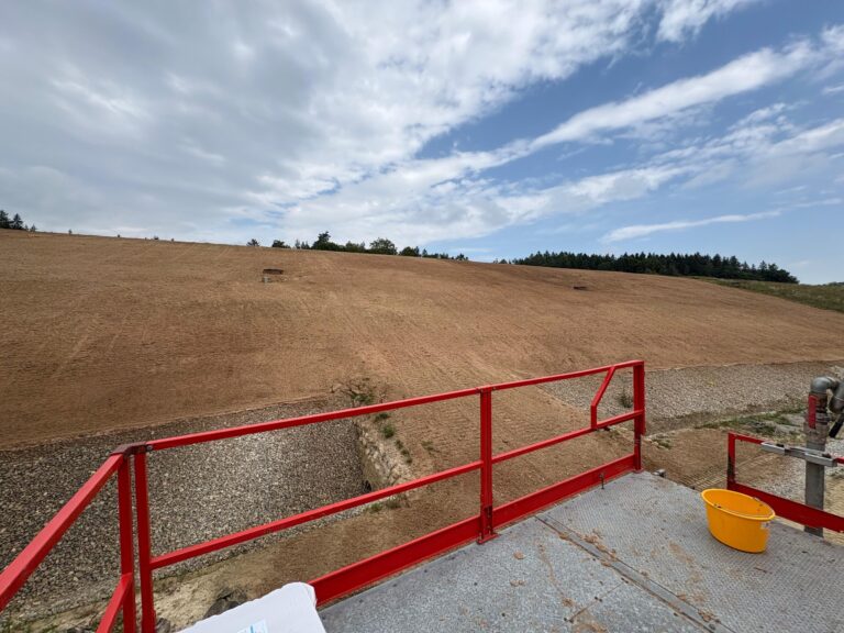 Large capped embankment after hydraulic application of growth medium