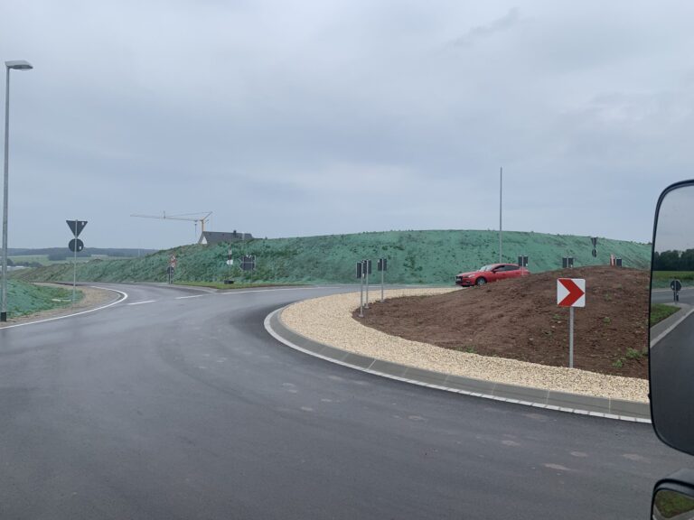 Hydroseeded embankments with green mulch at a newly built roundabout