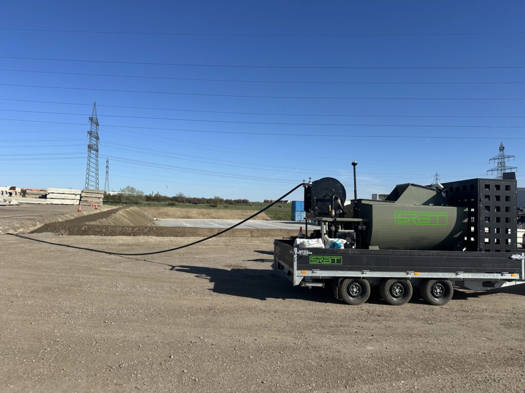 Trailer-mounted SRBT hydroseeder applying sprayable surface stabilization